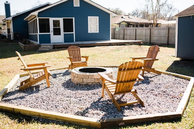 exterior space with a fire pit and a sunroom