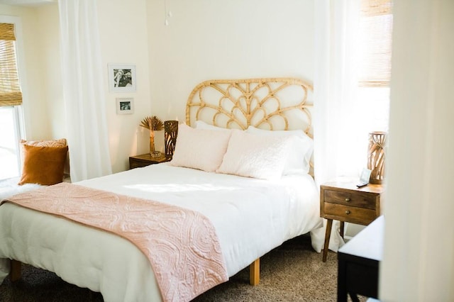 bedroom featuring multiple windows and carpet floors