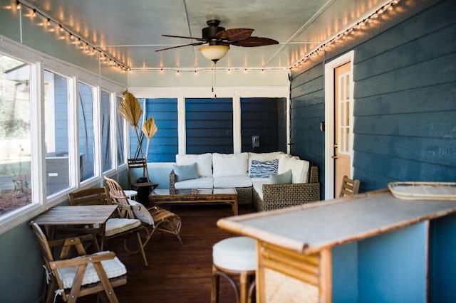 sunroom / solarium featuring ceiling fan