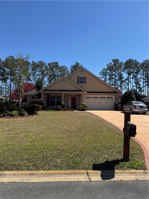 view of front of home featuring concrete driveway, a garage, and a front lawn