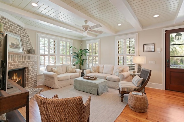 622 Beachview Dr, Saint Simons Island, GA 31522 - living area with wood finished floors, a fireplace, a ceiling fan, and a wooden ceiling with exposed beams