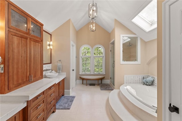 622 Beachview Dr, Saint Simons Island, GA 31522 - full bathroom featuring a garden tub, a shower stall, a skylight, double vanity, and vaulted ceiling