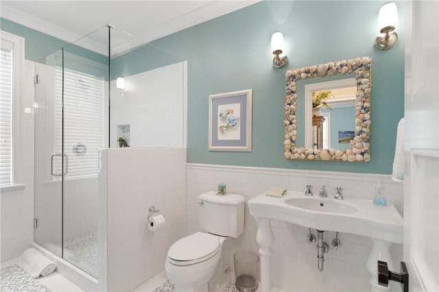 622 Beachview Dr, Saint Simons Island, GA 31522 - bathroom with a shower stall, tile walls, and wainscoting