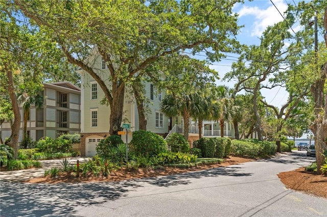 622 Beachview Dr, Saint Simons Island, GA 31522 - view of building exterior with an attached garage and concrete driveway