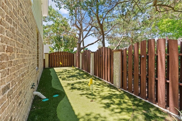 622 Beachview Dr, Saint Simons Island, GA 31522 - view of yard with a gate and a putting area