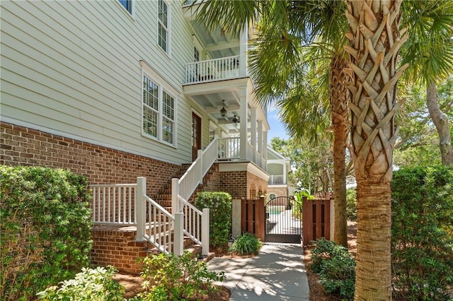 622 Beachview Dr, Saint Simons Island, GA 31522 - property entrance featuring a gate, brick siding, and a balcony