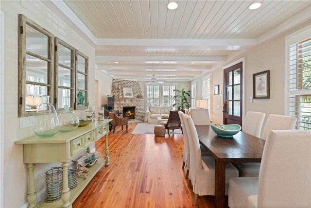 622 Beachview Dr, Saint Simons Island, GA 31522 - dining room featuring ceiling fan, a fireplace, light wood-type flooring, recessed lighting, and a wooden ceiling with exposed beams