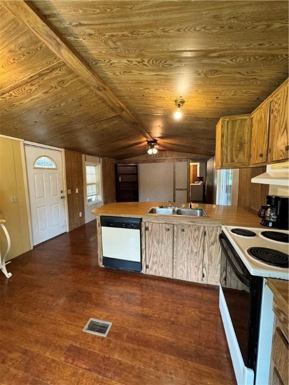 kitchen featuring lofted ceiling with beams, dark hardwood / wood-style floors, white appliances, and kitchen peninsula