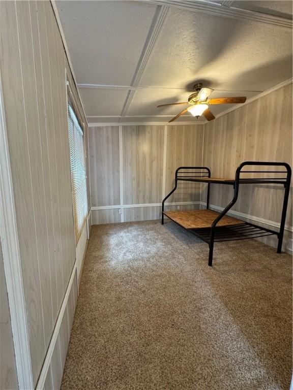 145 Getaway Ln, Surrency, GA 31563 - unfurnished bedroom featuring wood walls and carpet flooring