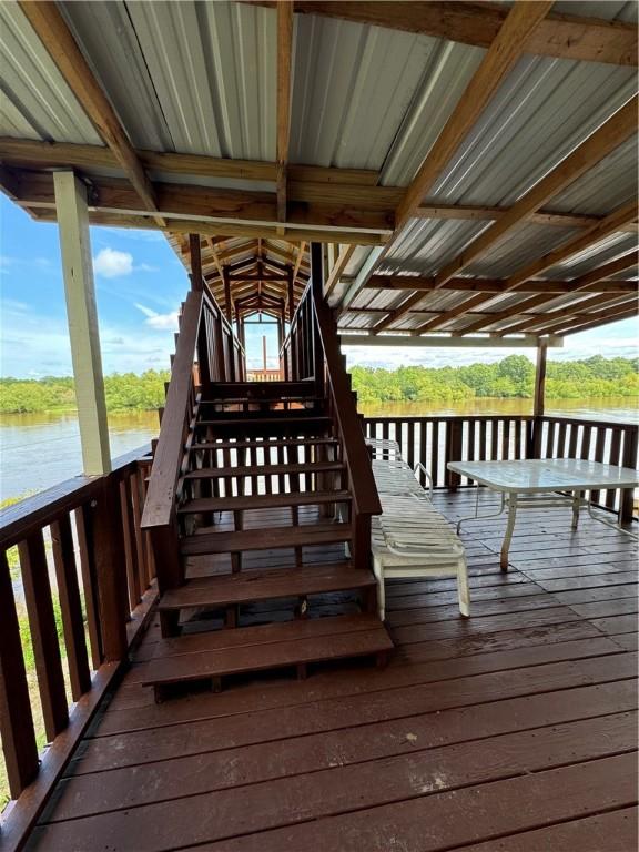 wooden terrace featuring a water view