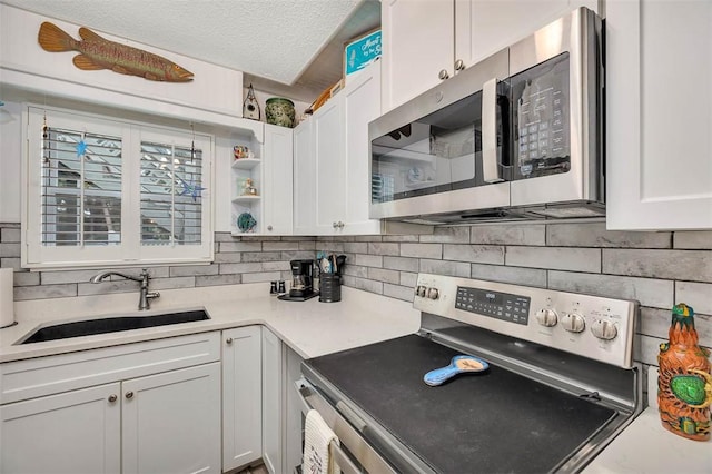 kitchen featuring backsplash, sink, white cabinetry, and stainless steel appliances