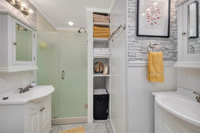 bathroom featuring tile patterned flooring, vanity, walk in shower, and ornamental molding