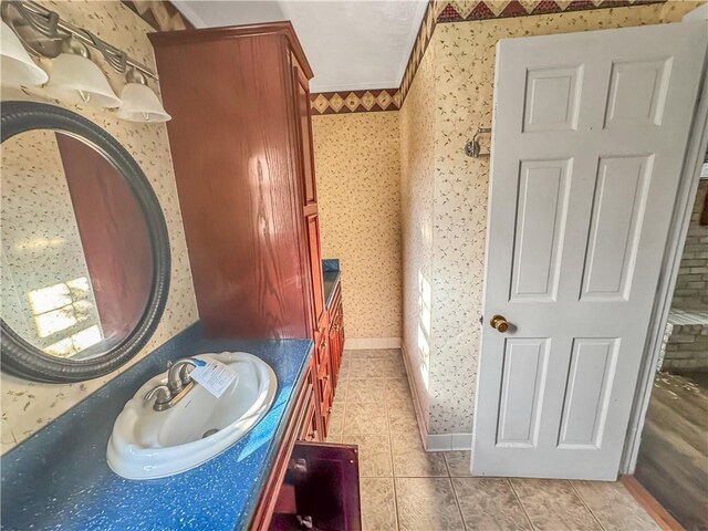 209 Lewis Dr, Rincon, GA 31326 - bathroom featuring wallpapered walls, tile patterned flooring, vanity, and crown molding
