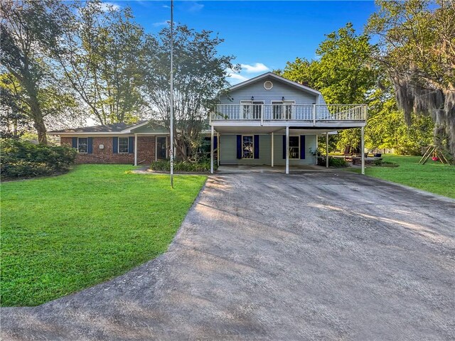 209 Lewis Dr, Rincon, GA 31326 - view of front facade with asphalt driveway, a front yard, and a deck