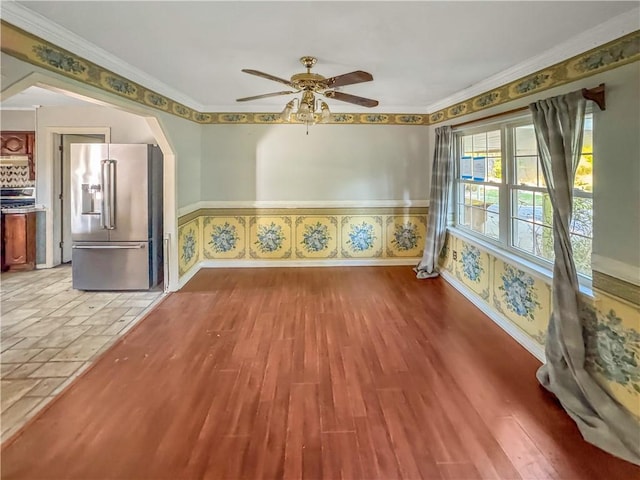 209 Lewis Dr, Rincon, GA 31326 - empty room with ceiling fan, wainscoting, light wood-style flooring, and ornamental molding