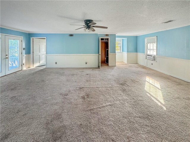 209 Lewis Dr, Rincon, GA 31326 - spare room with wainscoting, a textured ceiling, a ceiling fan, crown molding, and carpet flooring
