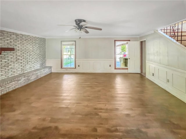 209 Lewis Dr, Rincon, GA 31326 - unfurnished living room featuring a ceiling fan, brick wall, plenty of natural light, ornamental molding, and stairs