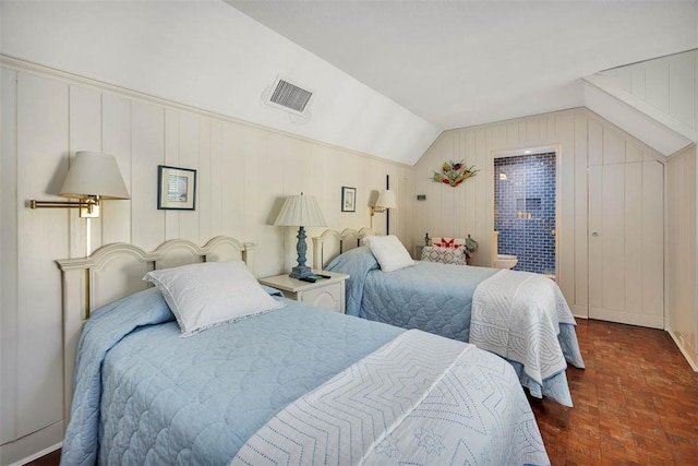 bedroom featuring lofted ceiling and visible vents