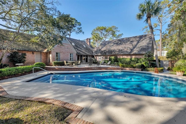 outdoor pool with a patio area