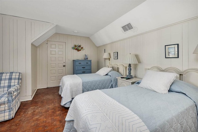 bedroom featuring vaulted ceiling and visible vents