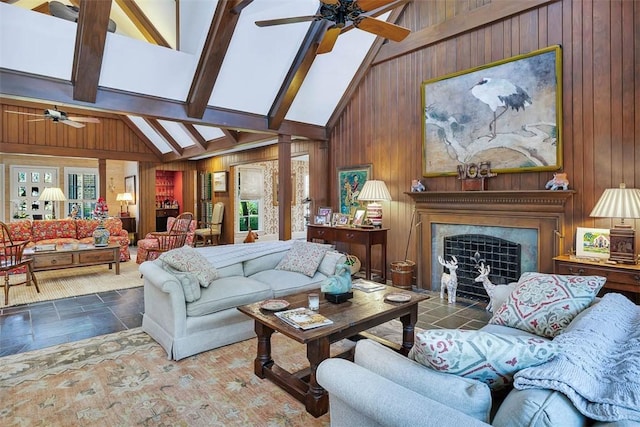 living area featuring stone finish flooring, wood walls, and a premium fireplace