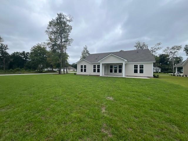rear view of house with a yard