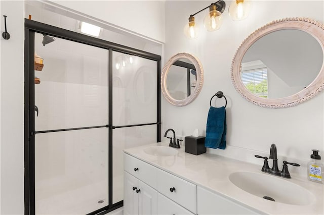 bathroom with a sink, a stall shower, and double vanity