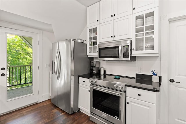 kitchen with white cabinetry, appliances with stainless steel finishes, and dark countertops
