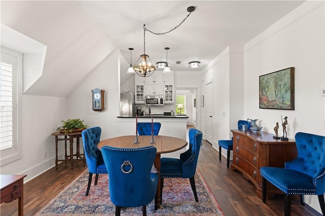 dining area featuring baseboards, a chandelier, vaulted ceiling, and dark wood-type flooring