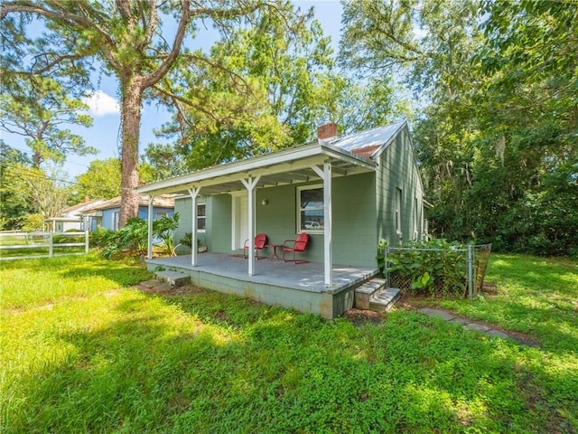 exterior space with a porch and a front lawn