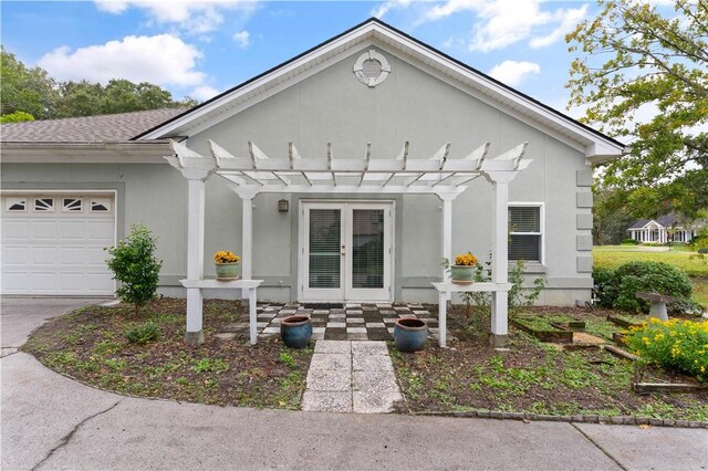 view of front of property featuring french doors and a garage