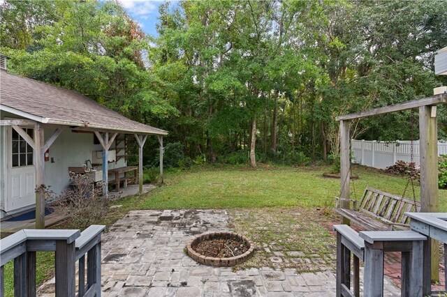 view of yard featuring an outdoor fire pit and a patio area