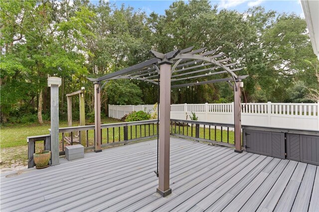 wooden deck featuring a pergola and a yard