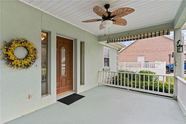 property entrance featuring covered porch and ceiling fan