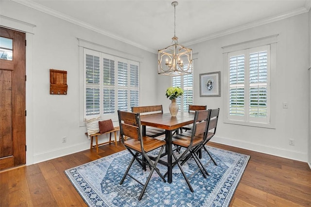 dining space with ornamental molding, dark wood-type flooring, and a chandelier