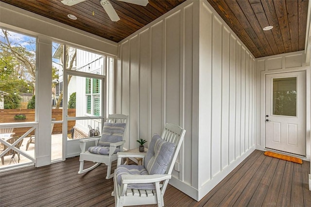 sunroom featuring ceiling fan and wooden ceiling