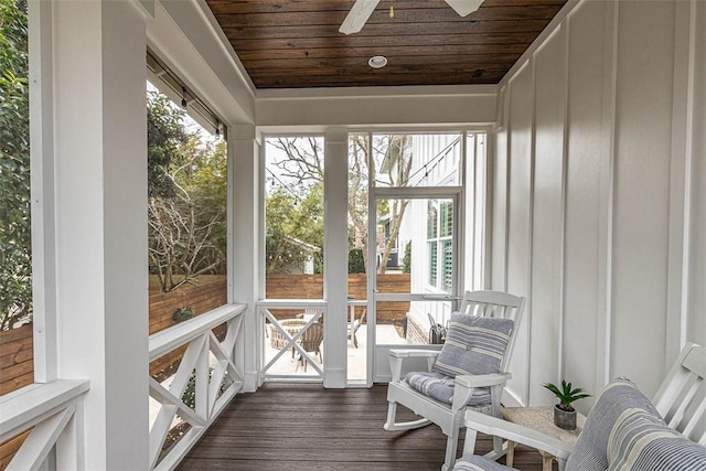 sunroom featuring ceiling fan and wood ceiling