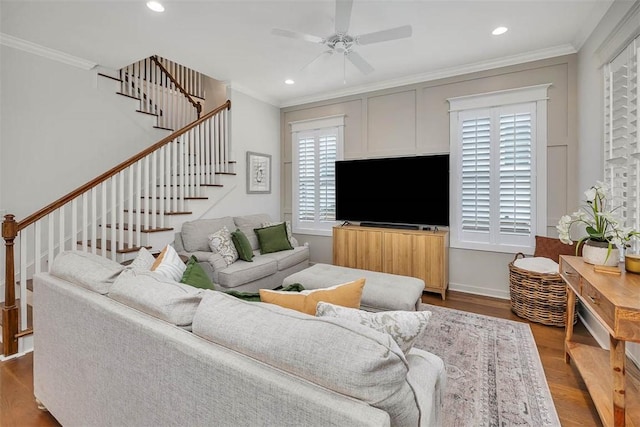 living room featuring ceiling fan, hardwood / wood-style floors, plenty of natural light, and ornamental molding