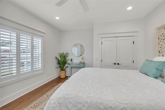 bedroom with a closet, ceiling fan, and dark wood-type flooring