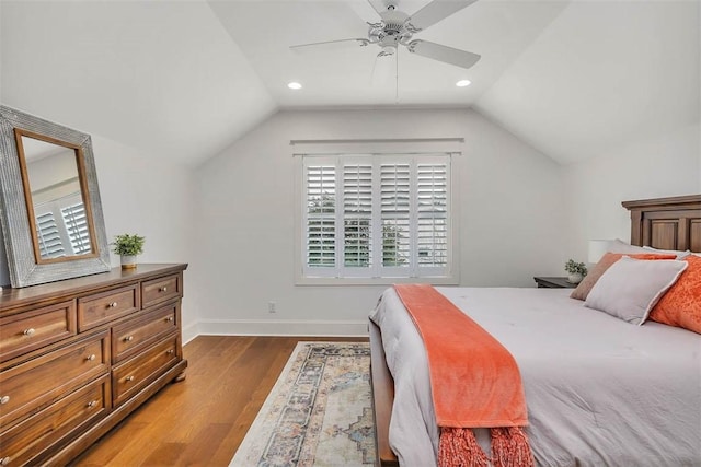 bedroom with hardwood / wood-style flooring, ceiling fan, and lofted ceiling