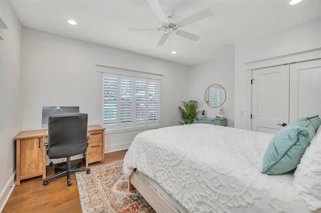 bedroom featuring ceiling fan, a closet, and light hardwood / wood-style flooring