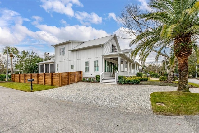 view of front of house with a front yard and a porch