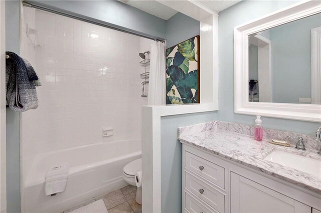 full bathroom featuring tile patterned flooring, vanity, toilet, and shower / tub combo with curtain