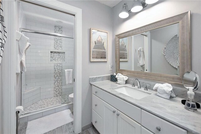 bathroom with vanity, toilet, and walk in shower
