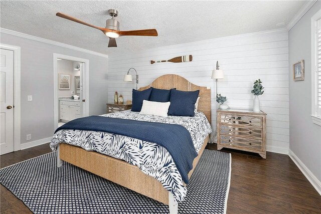 bedroom featuring connected bathroom, crown molding, ceiling fan, and dark wood-type flooring