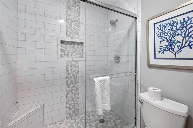bathroom with toilet and walk in shower