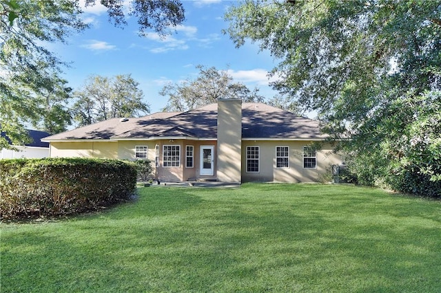 back of house featuring a yard