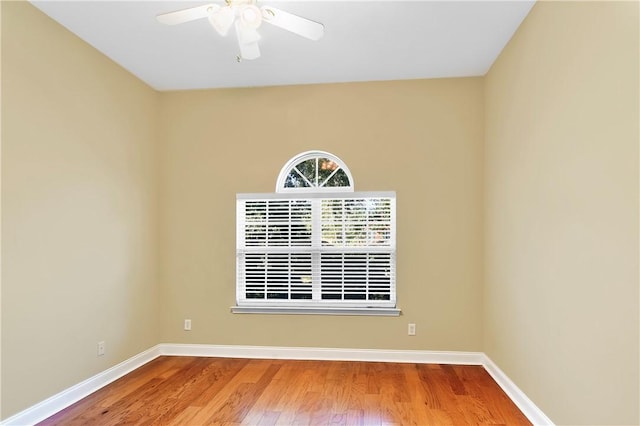 spare room featuring hardwood / wood-style floors and ceiling fan