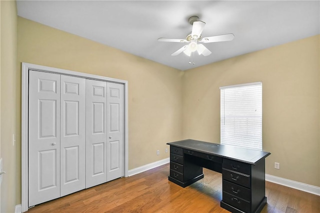 home office featuring light wood-type flooring and ceiling fan