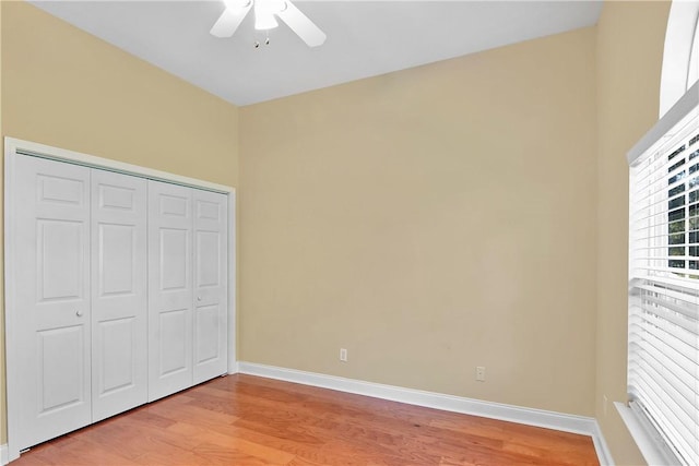 unfurnished bedroom with a closet, ceiling fan, and light hardwood / wood-style flooring